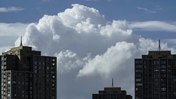 Cumulonimbus Clouds Between Buildings