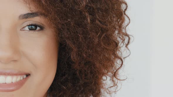 Close Up Young African American Smiling Toothy Happy Curly Hair Woman Face Half Opening Eye and