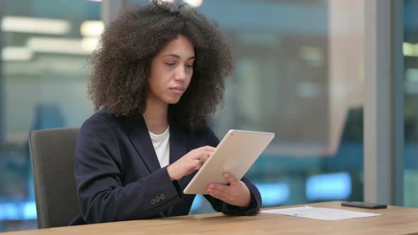 African Businesswoman Using Digital Tablet for Work
