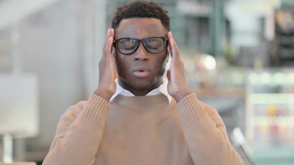 Creative African Man Having Headache