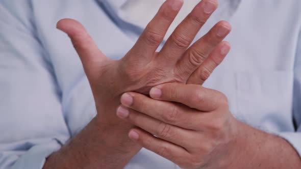 An elderly man's hand is trembling because of Parkinson's disease.