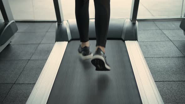 Fitness concept. close up feet are running on a treadmill