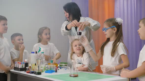 Chemical Experiments for Children. Pouring and Mixing the Ingredients in the Flasks. Fun Experiments