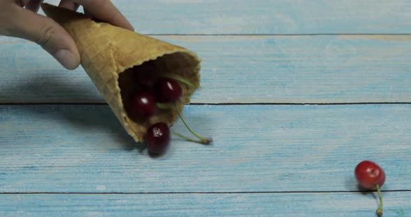 Berry Ice Cream Berries of Cherry in a Waffle on a Blue Wooden Background