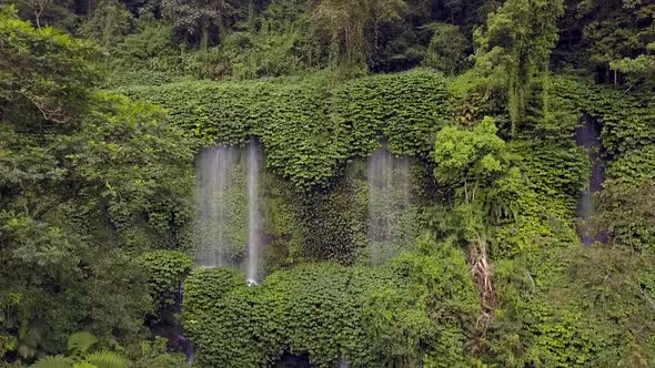 Slow motion of a waterfall on the mountain.Great aerial view flight pull back drone footageWaterfa