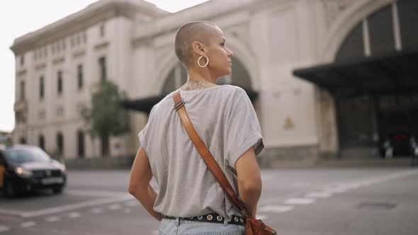 Bald woman wearing t-shirt walking