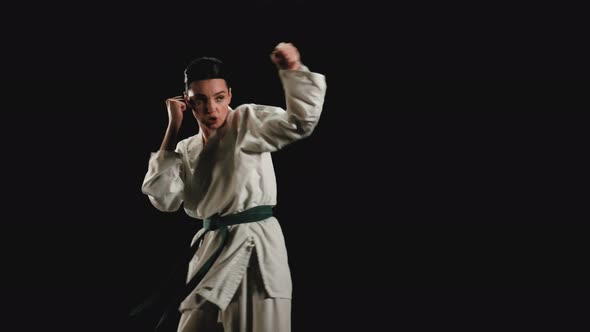 Young Woman in Kimono Practicing Karate Kicks