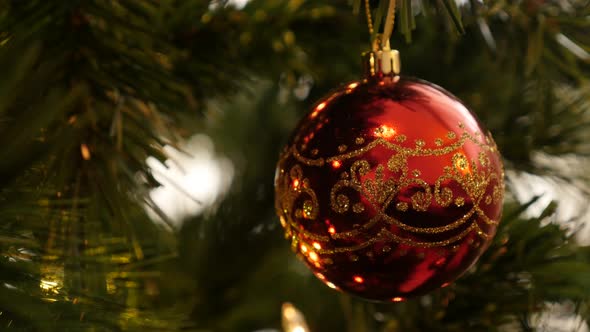 Shiny Christmas tree decoration close-up 4K 2160p 30fps UltraHD footage - Detailed red bauble hanged