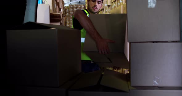 Delivery driver loading his van with boxes