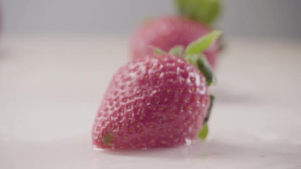 Strawberry Falls Down on Heap of Fresh Berries with Water Drops Slow Motion alt