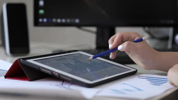 Accountant works with financial charts on a tablet