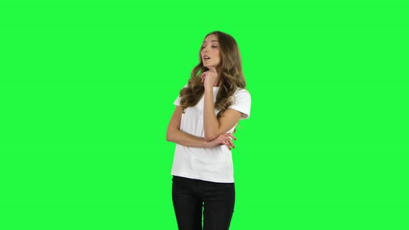 Lovable Girl Communicates with Someone in a Friendly Manner. Green Screen