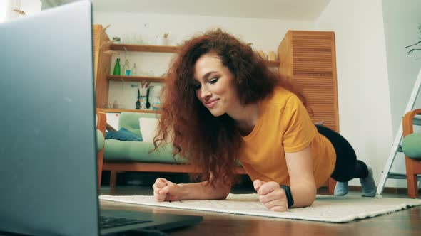 A Woman Is Smiling While Exercising at Home