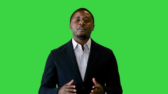 African American in a Black Jacket Talking on Camera on a Green Screen Chroma Key