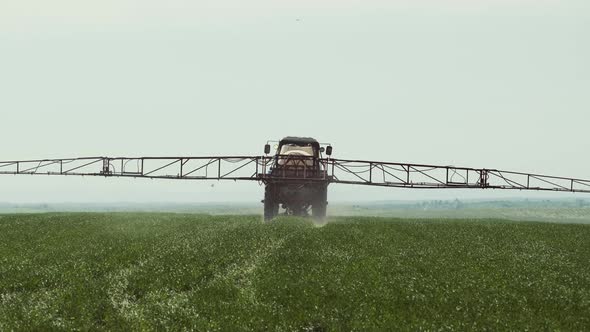 Tractor With A Sprayer Work In The Field.