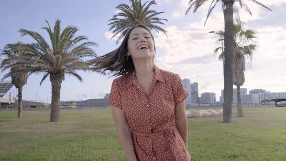 Young Beautiful Caucasian Woman Dances and Smiles Looking at the Camera