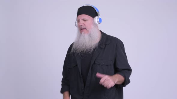 Mature Bearded Hipster Man Dancing While Listening To Music