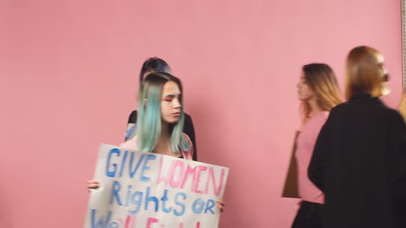 Young Confident Women Fighting for Women Rights Holding Posters