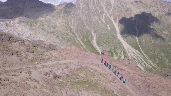 Hiking team climbing up the mountain slope