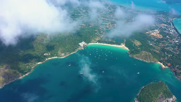 Aerial View Through Clouds of Phuket Island Nai Han Beach with Ships Thailand