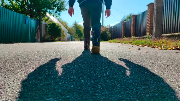 The Feet of a Small Child on the Road Walking