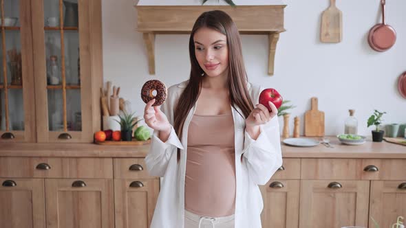 Pregnant Woman Prefers Fresh Red Apple to Sweet Donut