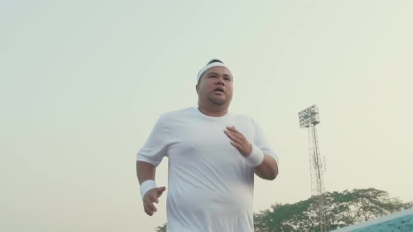Tried Fat Man Running For Exercising At Stadium