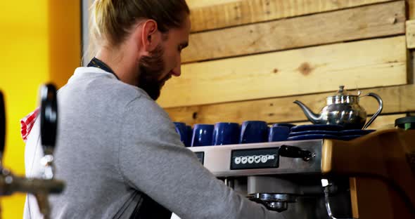 Waiter making cup of coffee