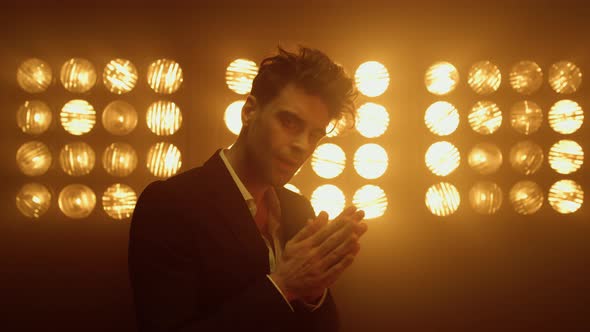 Model Man Rubbing Palms in Nightclub Light Closeup