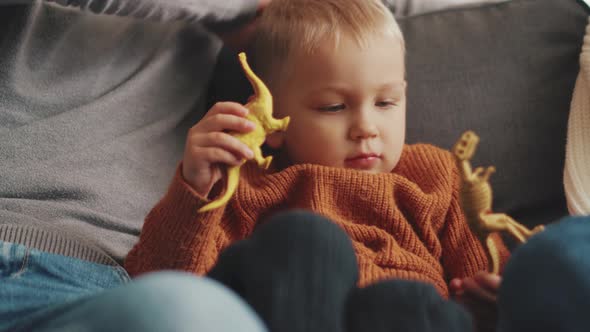 Concentrated little child playing with toys