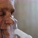 Close-up of an Old Woman with Closed Eyes Wearing a Medical Breathing Mask. - VideoHive Item for Sale