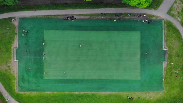 Aerial View of Men Playing Football on a Public City Soccer Field