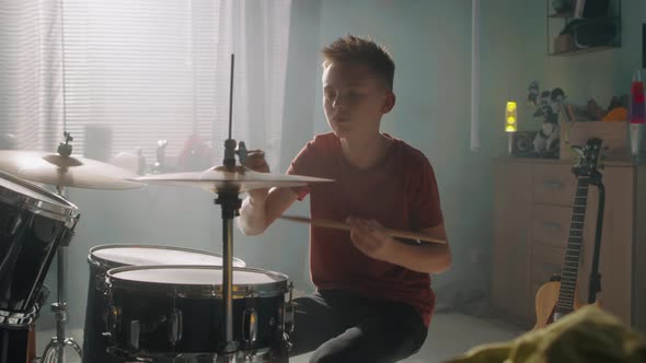 Teen Drummer Rehearsing in Sunlit Room