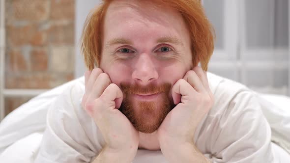 Yes By Young Redhead Beard Man Lying in Bed Shaking Head to Agree