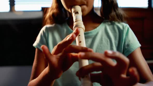 Schoolgirl playing flute in music class 4k