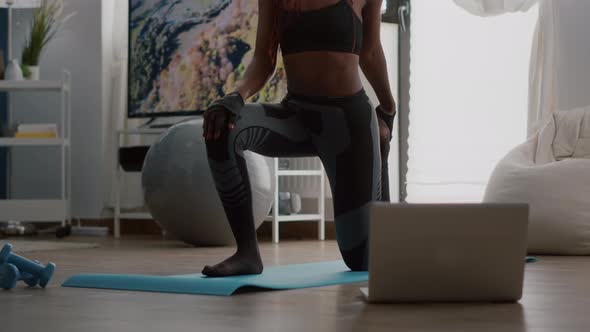 Fitness Woman with Dark Skin Practicing Yoga Workout in Living Room