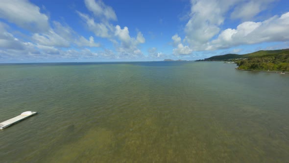 Flying Over Kaneohe Bay, FPV Drone Over Eastern Oahu Shore of Kaneohe, Kailua, on Sunny Summer Day w