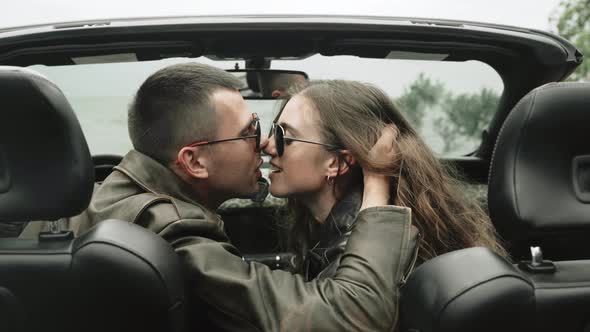 Young Couple Kissing in the Cabriolet Closeup