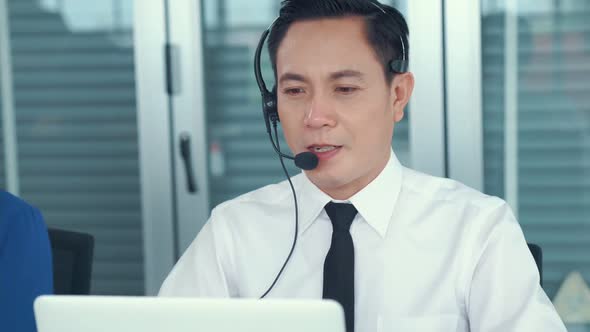 Business People Wearing Headset Working Actively in Office