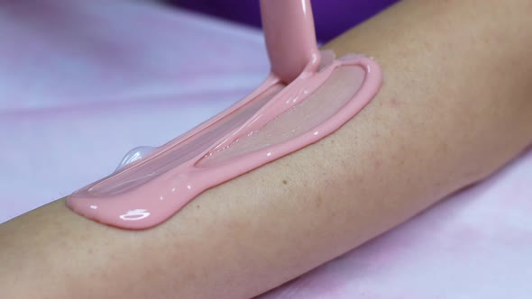 Waxing procedure on arms and legs hair removal. Women's beauty and care