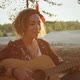 Young Attractive Girl Plays Acoustic Guitar in Camping - VideoHive Item for Sale