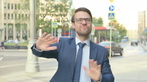 Businessman Dancing in Joy while Walking in Street