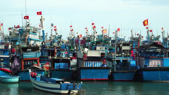 Vietnamese fishermen boats with flags. Static. Overfishing, pollution, sustainability