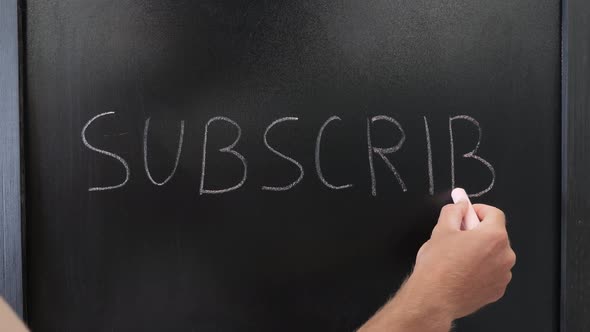 Word "Subscribe" written on black chalkboard