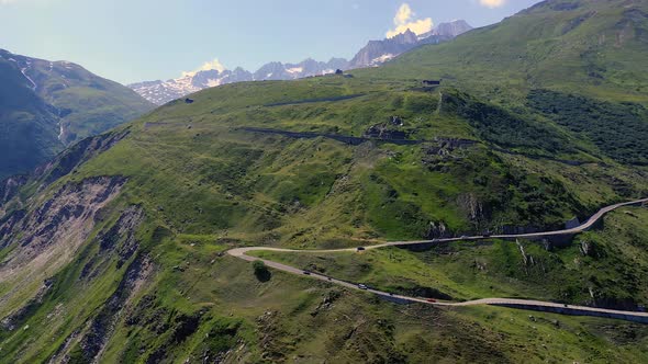 Aerial View of the Winding Road of Furka Pass in Switzerland with Moving Cars