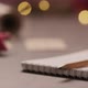 Notepad with Pencil on Walnut Wood Table with Christmas Lights on Background - VideoHive Item for Sale