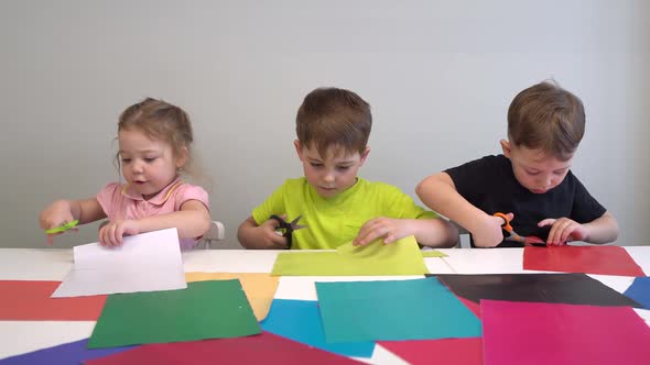 Happy Children Make Arts and Crafts Together at Their Table