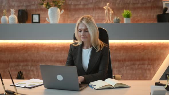 Overworked Upset Mature Businesswoman or Top Manager in Suit Tired of Working Online on Laptop