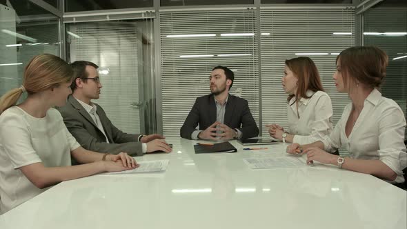 Closeup of Group of Business People Applauding at a Meeting