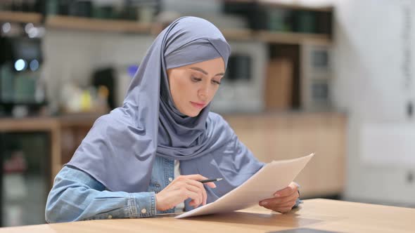 Professional Arab Woman Reading Documents at Work 